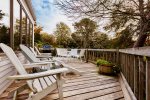 Main deck with grill and outdoor furniture overlooks the backyard and cranberry bog